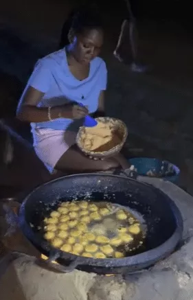 Lady who sells Akara at night in Abuja causes buzz as she flaunts her stunning transformation in fine outfit