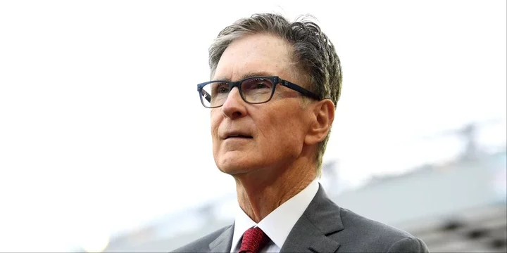 Liverpool owner John W. Henry walking along the touchline at Anfield