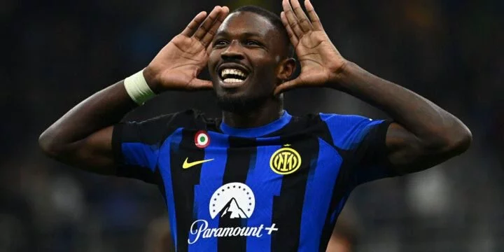 Marcus Thuram celebrating his goal  for Inter Milan in the club's home jersey with his hands on his ears