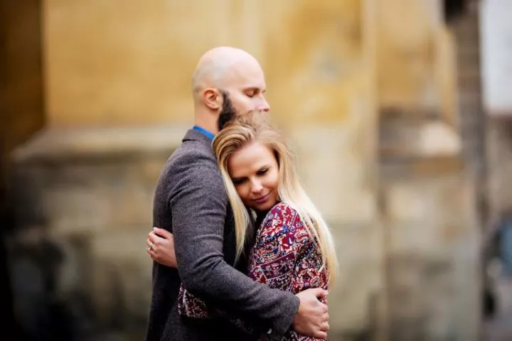 Young couple in love, hugging on the street. Photo: Davydiak Source: Getty Images