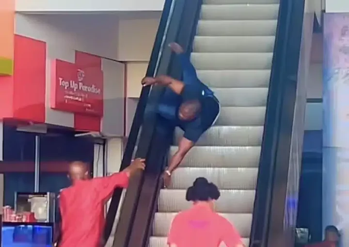 'No be head of the family dey ground so' - Reactions as man gets stuck on escalator