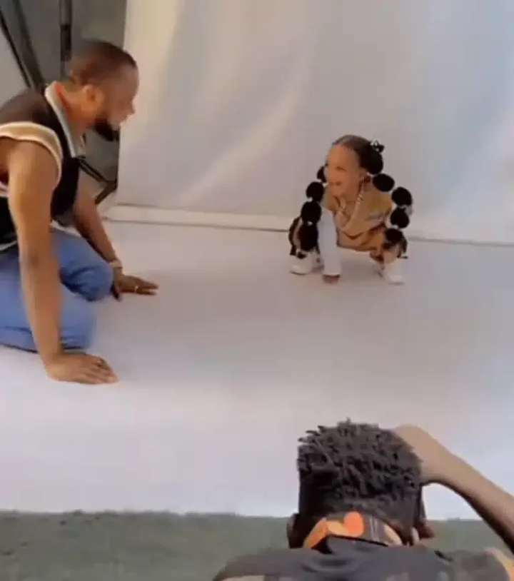 Father melts heart as he does stunts to make daughter smile during photoshoot