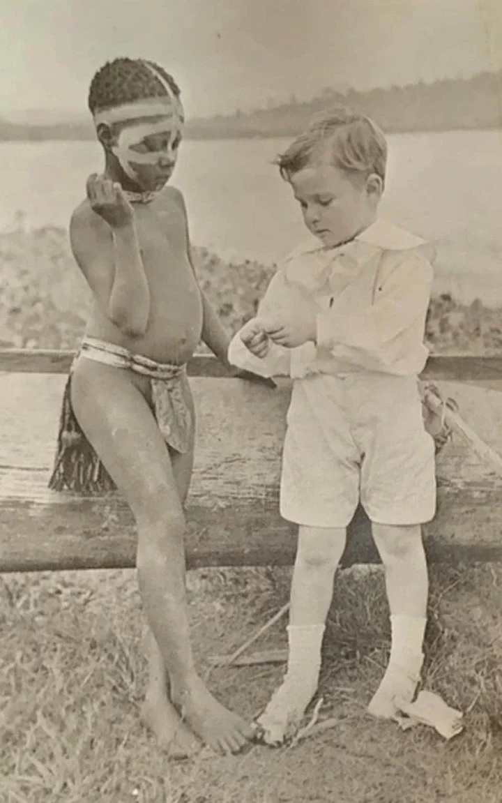 John, the son of the islands' deputy commissioner, with an indigenous boy in 1914