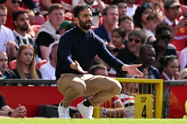Ruben Amorim gets down on his haunches on the Old Trafford touchline.