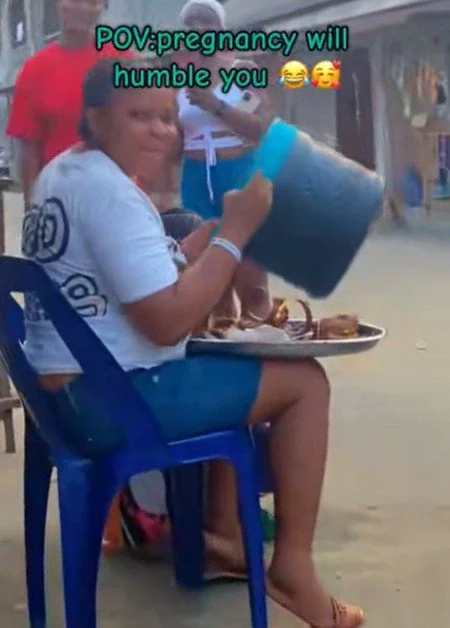 'Pregnancy will humble you' - Moment a pregnant woman drinks 'garri' using a food cooler (Watch)