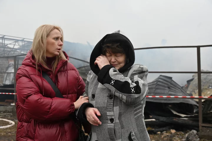 A Ukrainian resident weeps after her neighbours' house was destroyed in a drone strike in Kharkiv