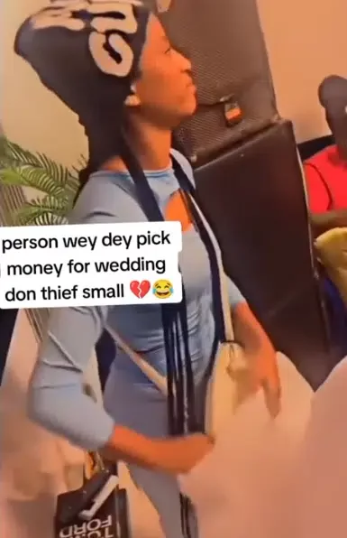 'Someone's serious babe' - Video of lady stealing couple's money at wedding causes buzz