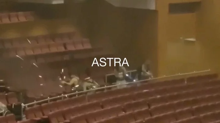 This grab taken from a UGC video shows gunmen shooting in a concert hall