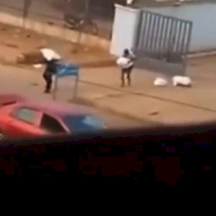 Military men spotted hiding as armed robbers cart away sacks of money in Edo (Video)