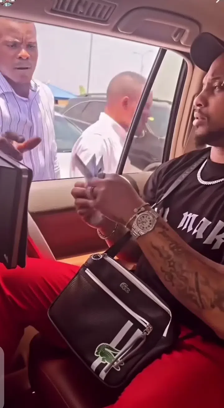 Davido's cousin, B-red spotted handing out money on the street (Video)