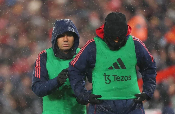 Casemiro of Manchester United warms up on the sidelines during the Premier League match between Liverpool FC and Manchester United FC at Anfield on...