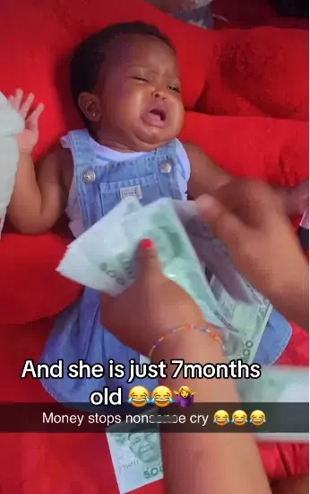 Dramatic moment baby stops crying as parent sprays her money
