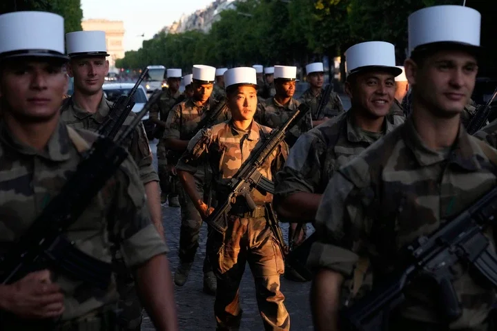 Foreign Legion soldiers arrive for a rehearsal for the upcoming Bastille Day parade