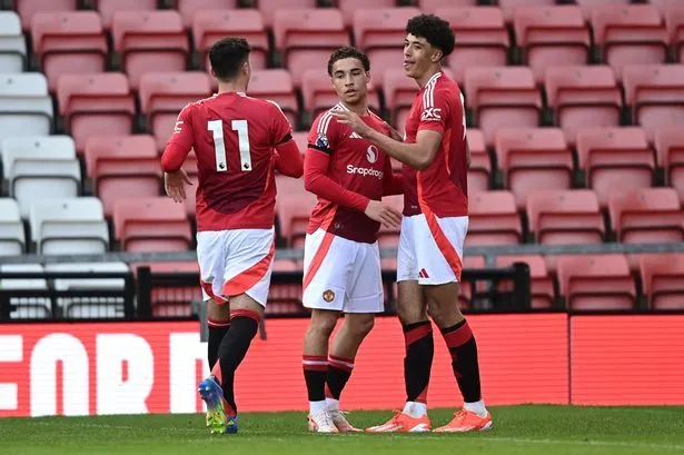 Sam Murray celebrates a goal for Manchester United's Under-21s with his teammates.
