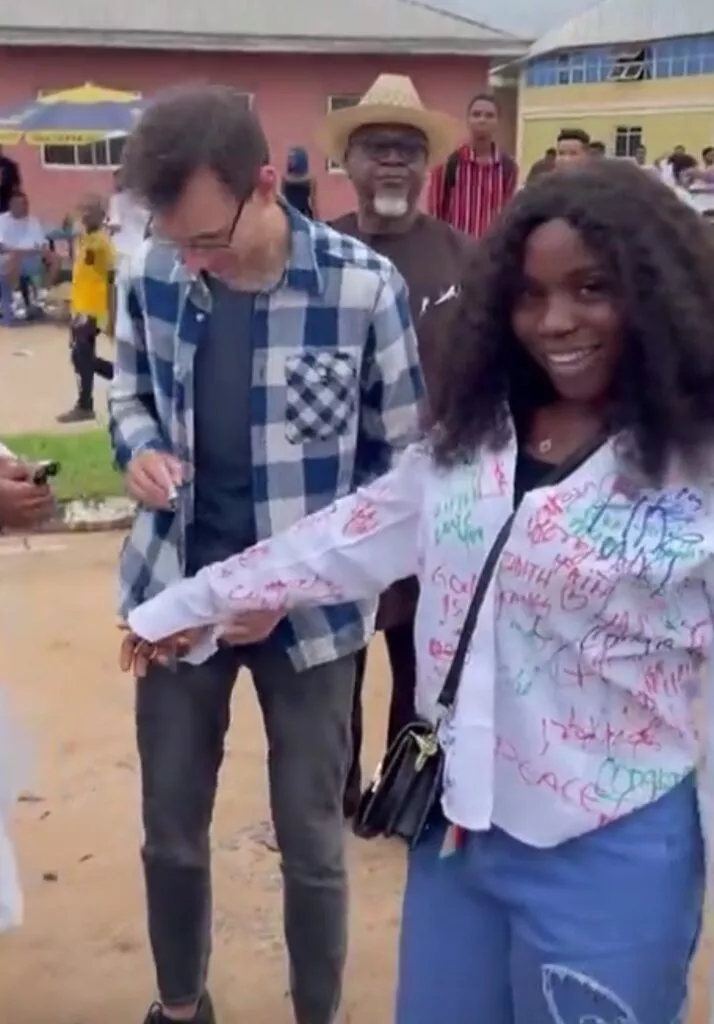 Lady excited as her Caucasian man flies in from US to attend her sign-out