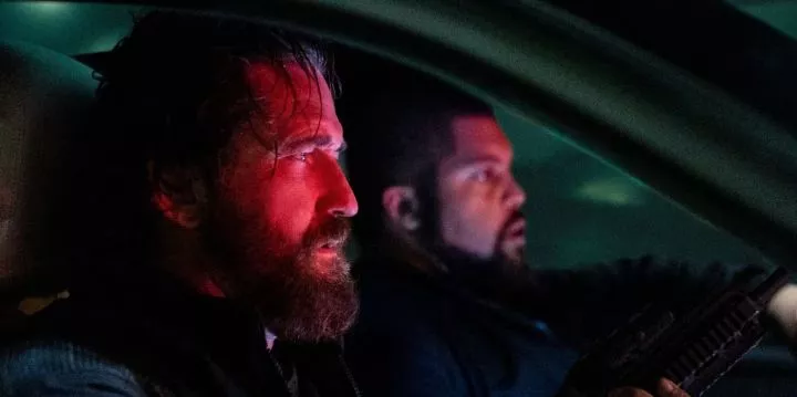 Gerard Butler and O'Shea Jackson Jr driving in a car in Den of Thieves 2: Pantera.