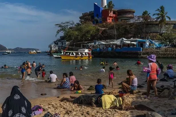 Visitors at Caleta beach in Acapulco, Guerrero state