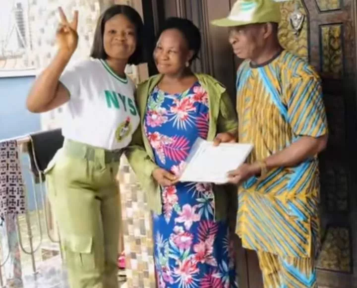 Lady soldier congratulate parents NYSC salutes certificate