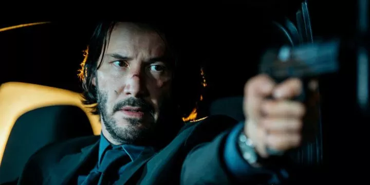 Keanu Reeves as the title character holding his gun in the first 'John Wick' (2014).