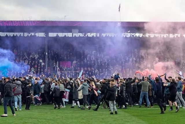 Burnley fans celebrate inside Turf Moor as the Clarets are promoted back to the Premier League following the 2-1 victory over Sheffield United. Photo: Kelvin Lister-Stuttard