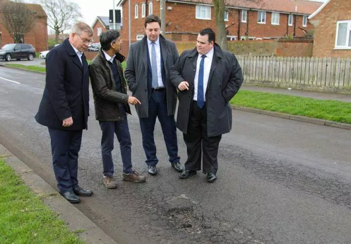 Nigerian potholes feeling jealous - Social media users react to trending photo of UK Prime Minister and his cabinet members posing in front of a pothole troubling their country
