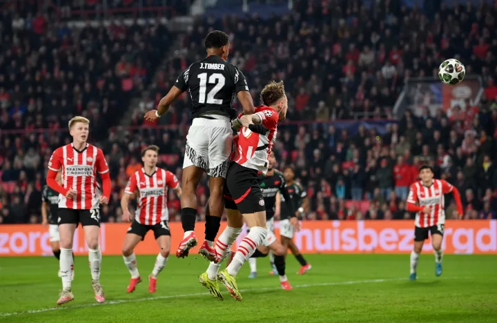 Jurrien Timber of Arsenal scoring a goal during a soccer match.