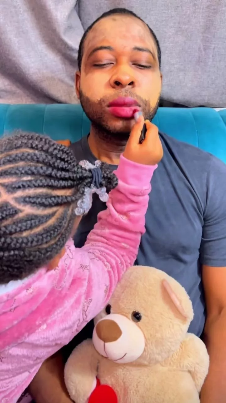 Adorable moment daughter uses dad's face to learn make-up