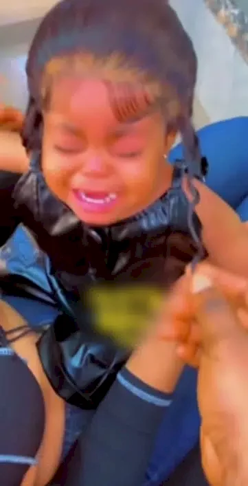 'Such an irresponsible mother' - Lady receives backlashes for fixing lace wig on her baby (Video)