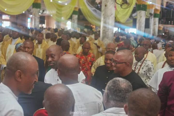Peter Obi and Chukwuma Soludo share a friendly hug at an inaugural Mass in Anambra state