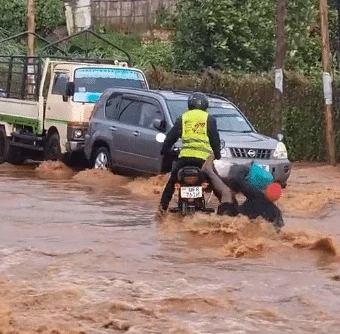 Okada rider causes buzz as woman falls from his bike in attempt to cross flooded road, leaves her drenched in mud water.