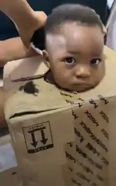 'This pikin no get joy' - Father puts troublesome son inside box to barb his hair