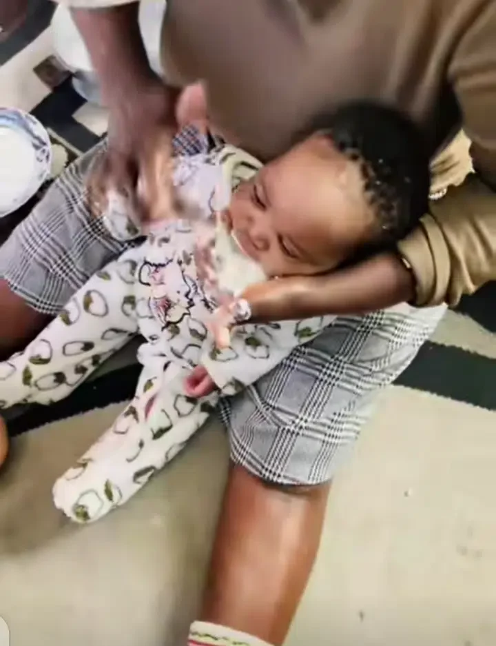 Nigerian lady stirs reactions with unique way of feeding her baby (video)