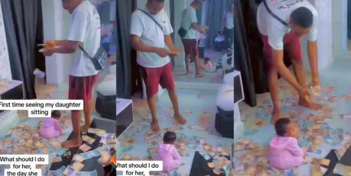 Young dad rains money on baby girl as she sits up without support for the first time (Video)