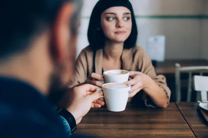 Girl, Hand, Tableware, Table, Drinkware, Cup, Coffee cup, Eyewear, Flash photography