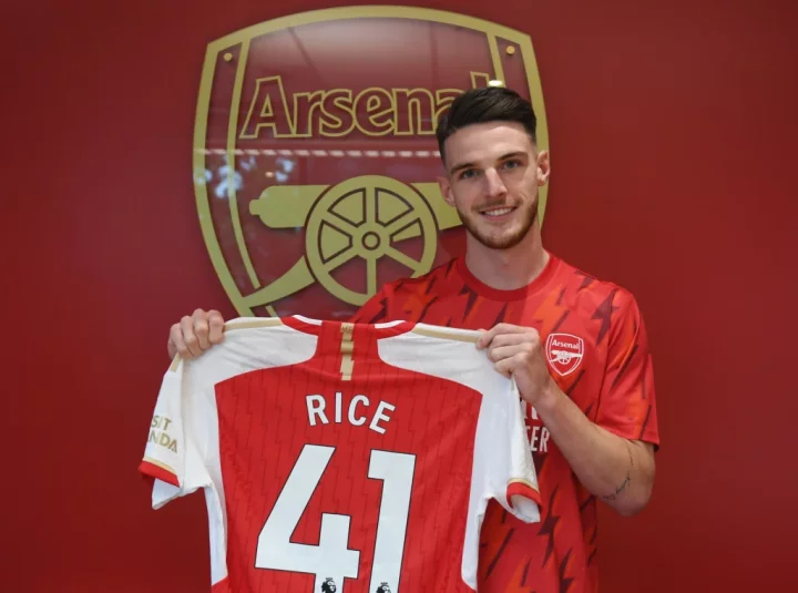 Declan Rice holds an Arsenal shirt