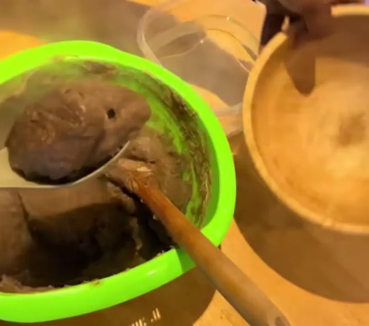 Nigerian woman causes stir online as she uses microwave to make Amala