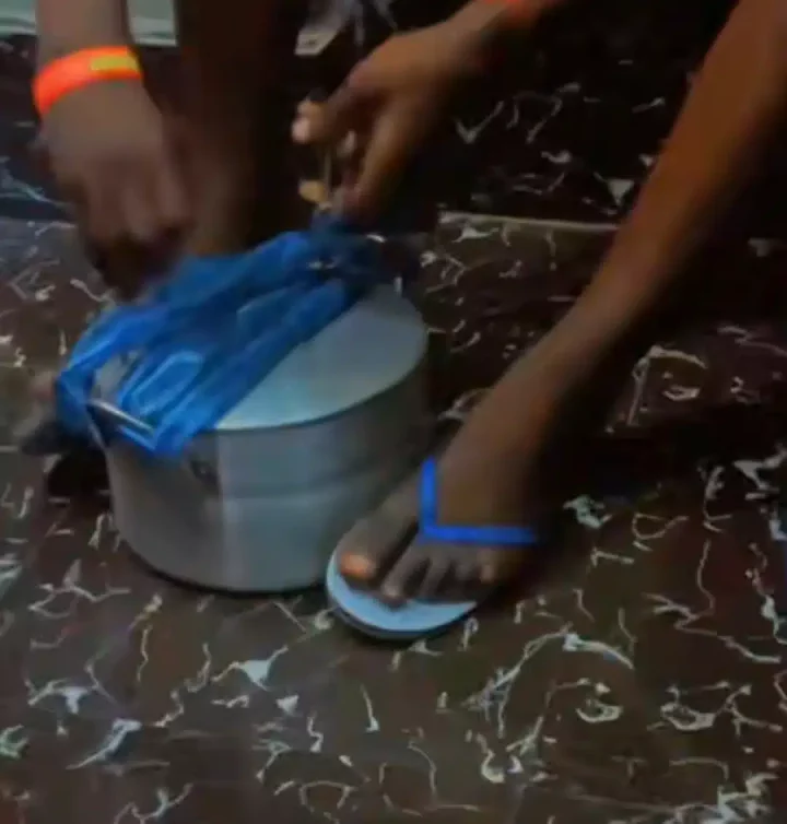 'E tough for everywhere' - Nigerian man causes stir as he locks pot of rice with padlock and chains