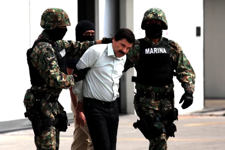 Mexican Navy soldiers handle Joaquin Guzman Loera - also known as 'El Chapo Guzman', leader of the Sinaloa Cartel, in 2014