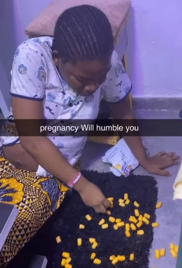 'Pregnancy will humble you' - Pregnant Nigerian woman causes buzz as she eats cheese balls from floor like baby