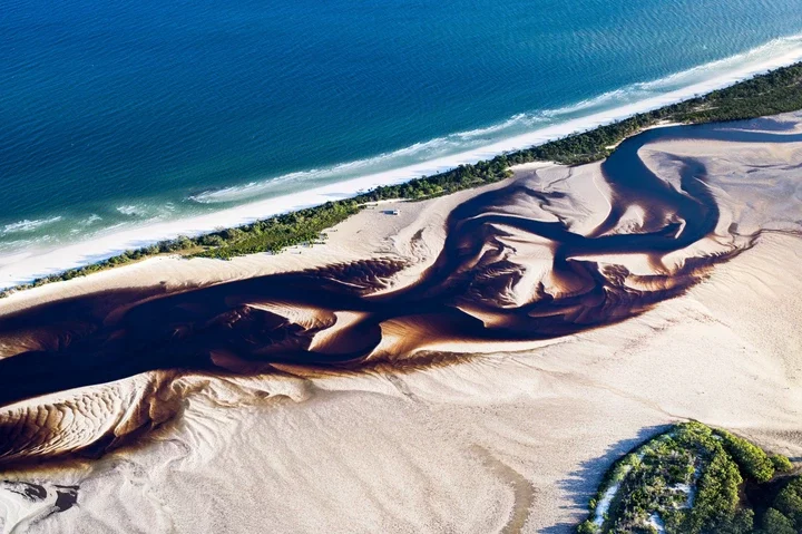 K'Gari Island boasts more than 150 miles of sandy beaches and ancient sand dunes