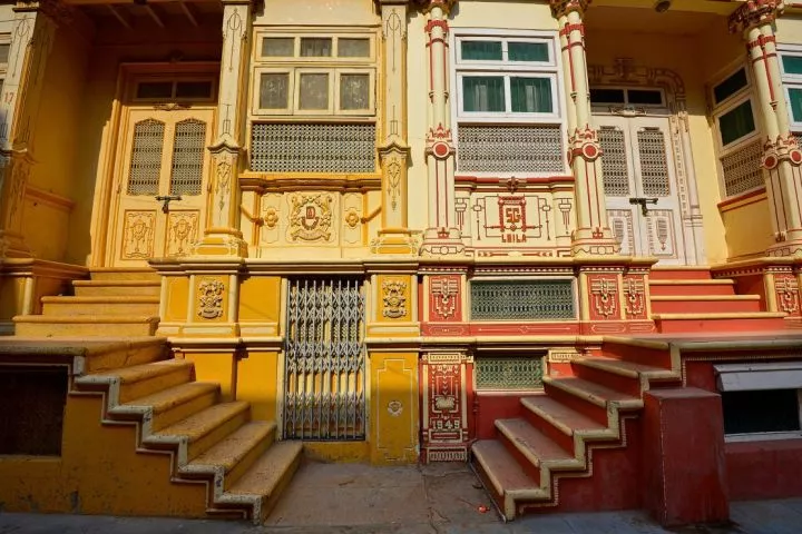 The colorful homes feature elaborate window, door and facade details.