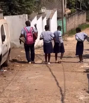 Young boy hailed a 'gentleman' as he carries his female classmates' bags