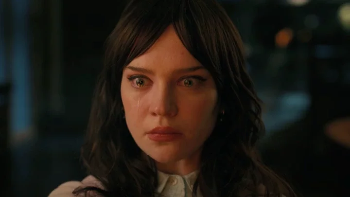 A woman cries as she stares ahead in 'Companion.