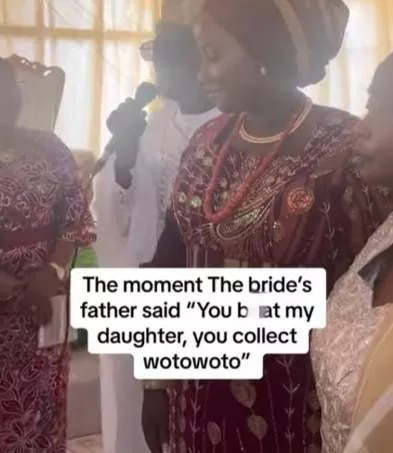 Moment bride's father sternly cautions groom during wedding