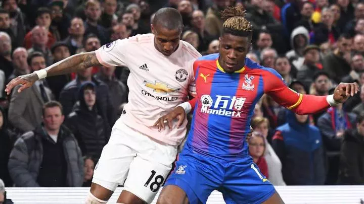 Ashley Young battles with Wilfried Zaha during Crystal Palace v Man Utd in Premier League at Selhurst Park