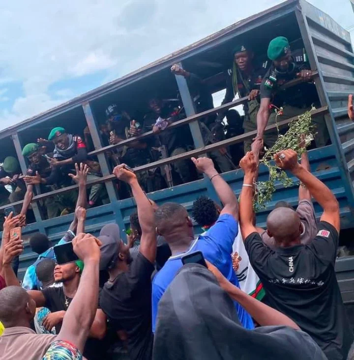 Reactions Trail Photo Of Policemen Shaking Some Protesters Who Were Hailing Them From Their Vehicle