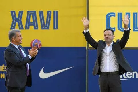 Barcelona coach Xavi Hernandez (right) alongside club president Joan Laporta at Camp Nou during his unveiling - X/@Barcelona