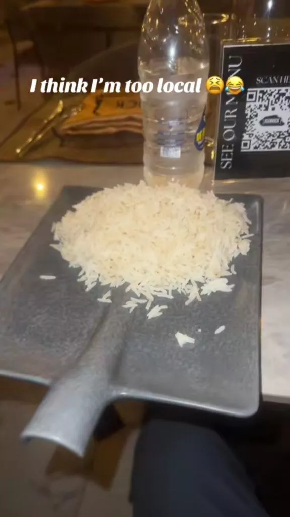 Man surprised after being served rice on a shovel at a restaurant