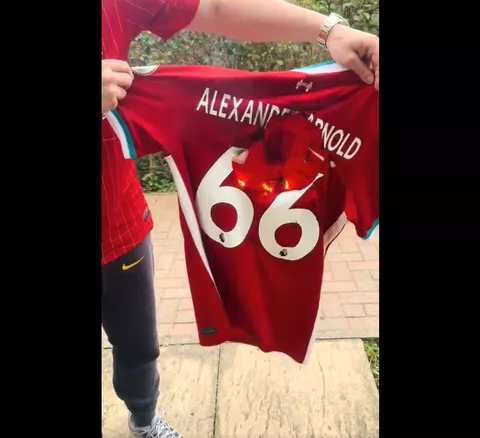 Liverpool fan burns down Arnold's jersey -- X