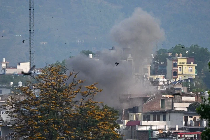Smoke billows after an artillery shell landed in the main town of Poonch district in India's Jammu region on 7 May 2025